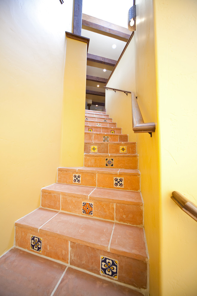 Gewendelte, Mittelgroße Mediterrane Treppe mit gefliesten Treppenstufen und gefliesten Setzstufen in Santa Barbara