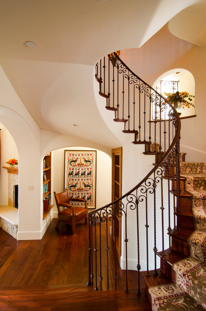 This is an example of a mediterranean wood curved staircase in San Francisco with wood risers.