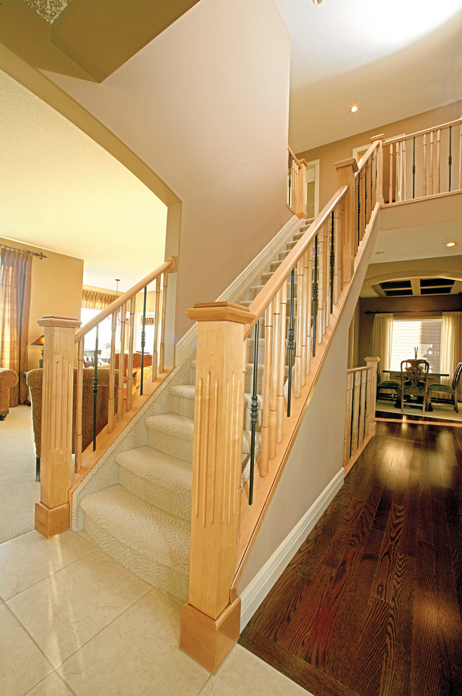 Photo of a large contemporary carpeted straight staircase in Calgary with carpeted risers.