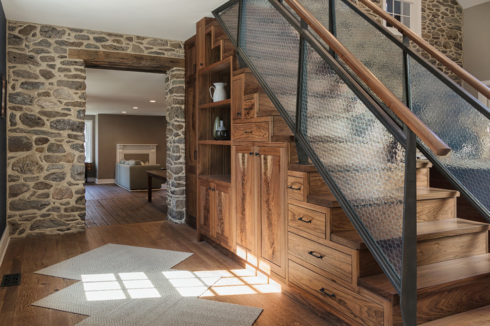 Mountain style wooden straight glass railing staircase photo in Philadelphia with wooden risers