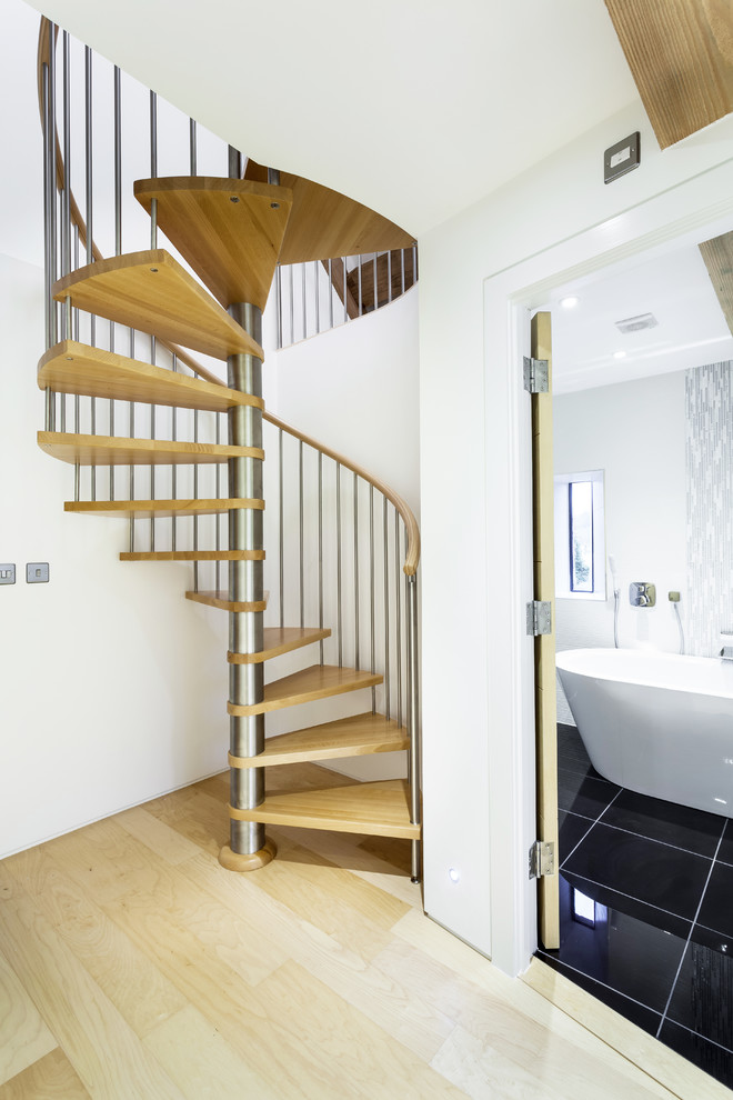 Design ideas for a small contemporary wood spiral staircase in Hampshire with open risers.