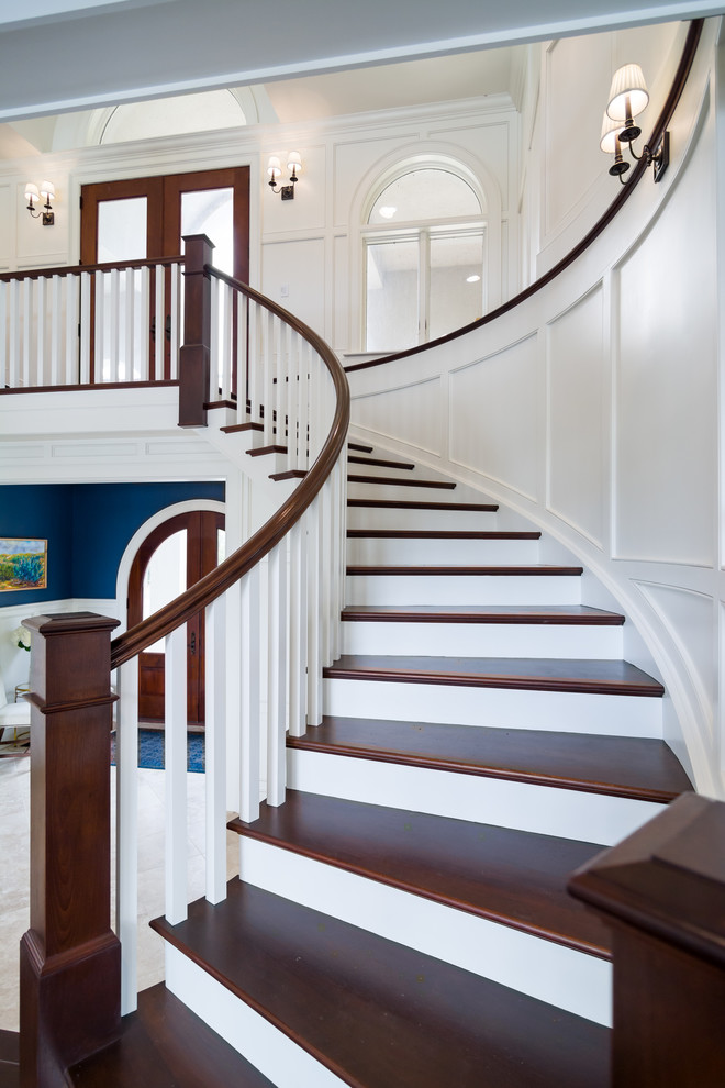 Staircase - coastal wooden spiral wood railing staircase idea in Other with painted risers