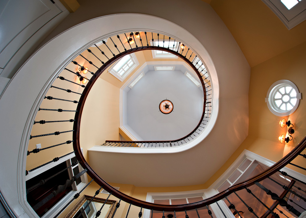 Inspiration for a traditional carpeted spiral staircase in New York with wood risers.