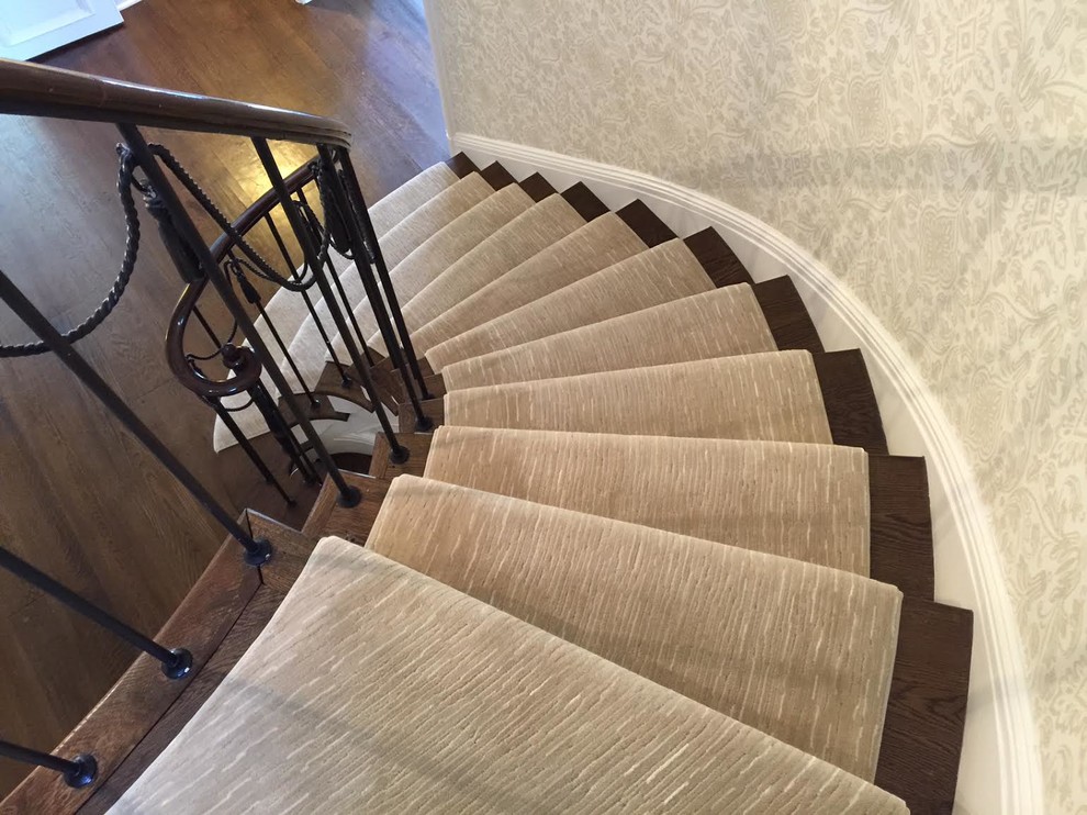 Inspiration for a mid-sized contemporary wooden curved staircase remodel in New York with wooden risers