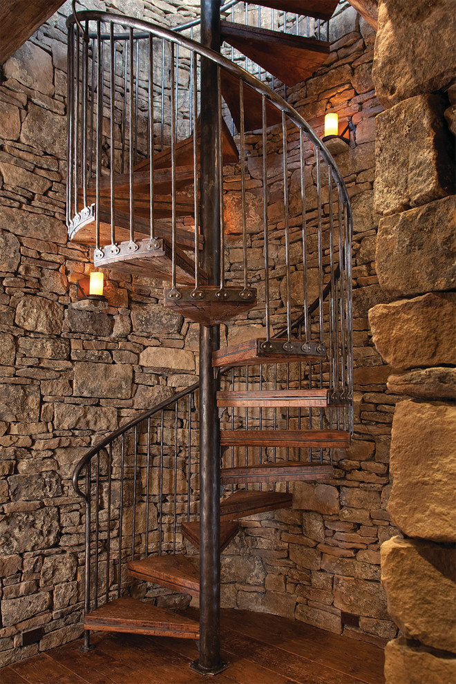 Inspiration for a large rustic wood spiral staircase in Denver with open risers.