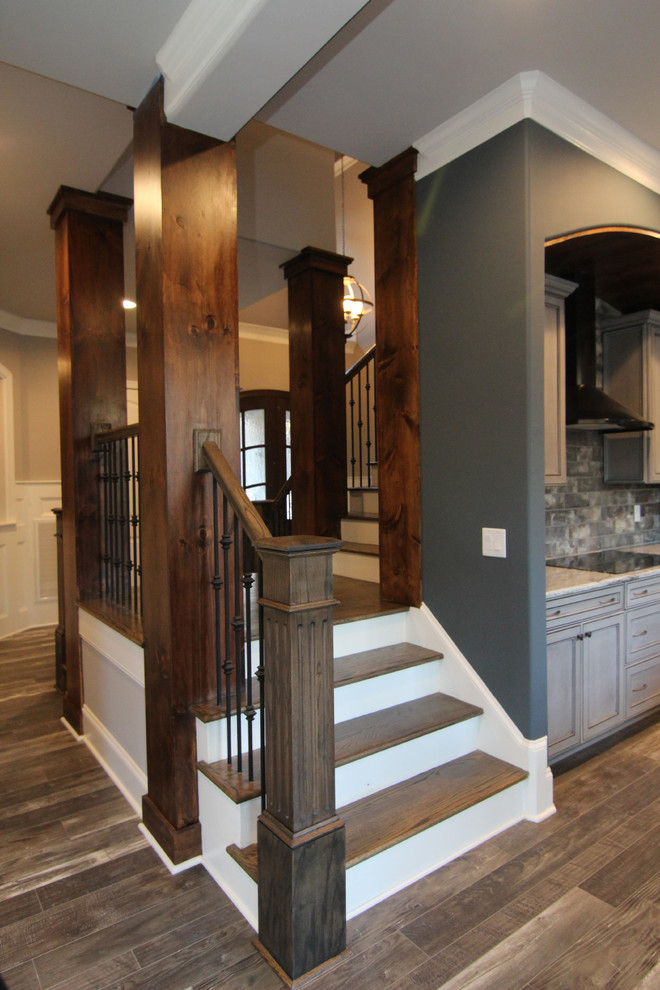 Inspiration for a large traditional wood l-shaped staircase in Raleigh with painted wood risers.