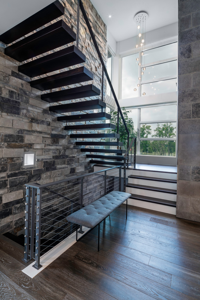 Modern wood floating metal railing staircase in Columbus with open risers.
