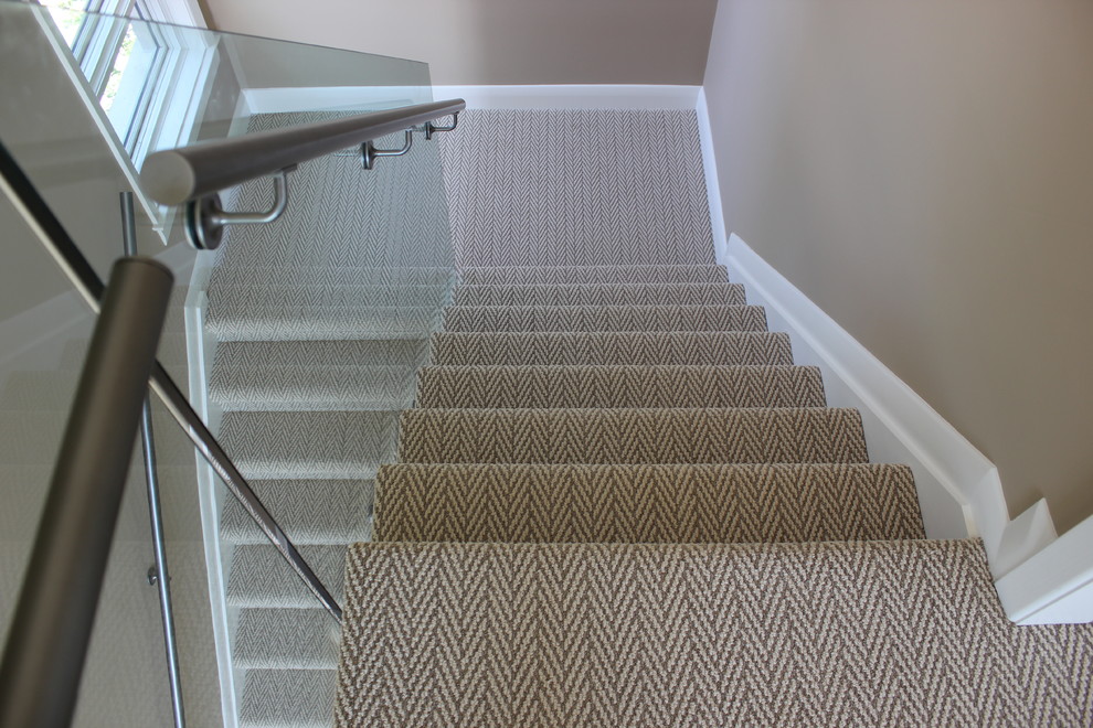 This is an example of a medium sized contemporary carpeted l-shaped staircase in Toronto with carpeted risers.
