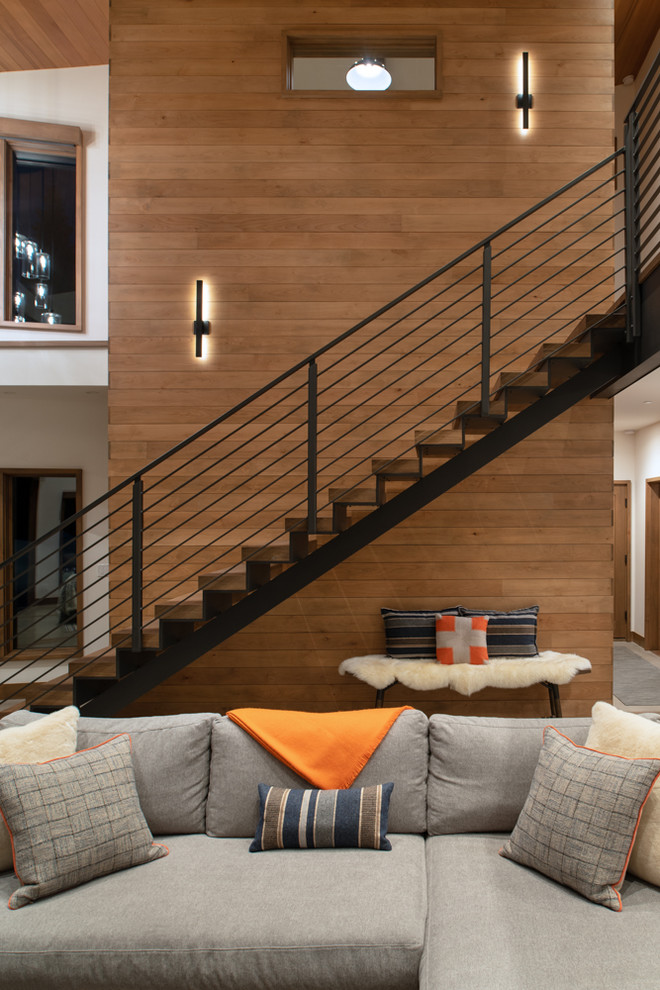 Photo of a medium sized modern wood floating metal railing staircase in Other with metal risers.