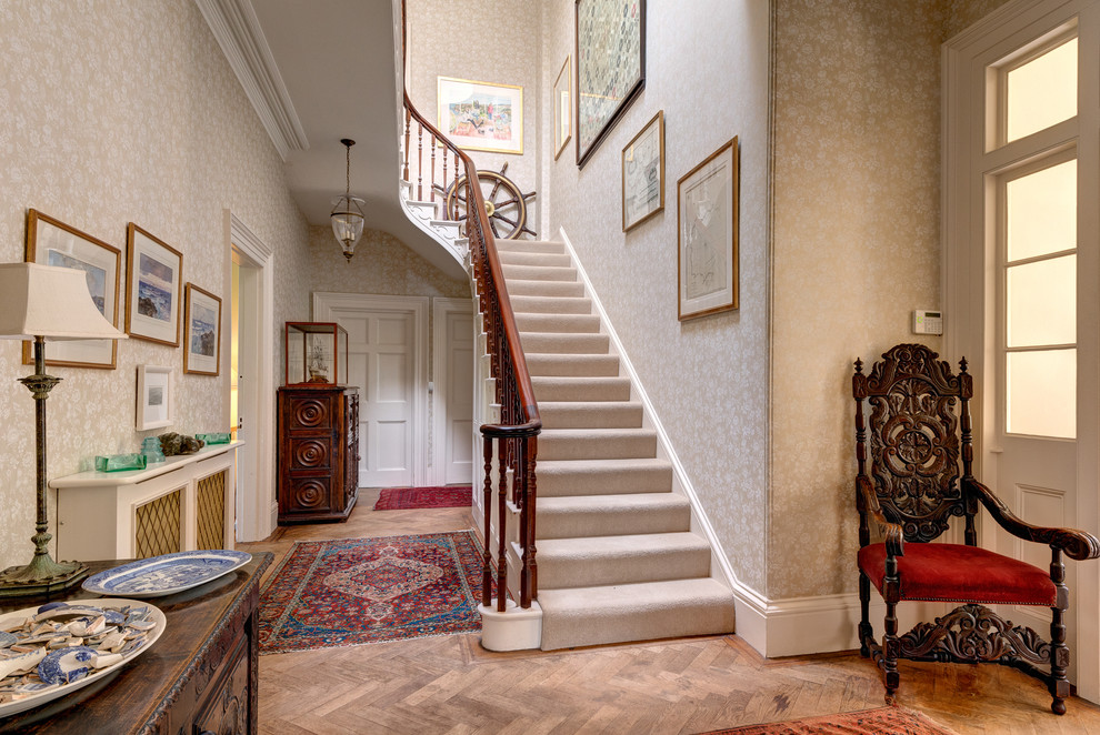 Photo of a traditional carpeted u-shaped staircase in Devon with carpeted risers and feature lighting.