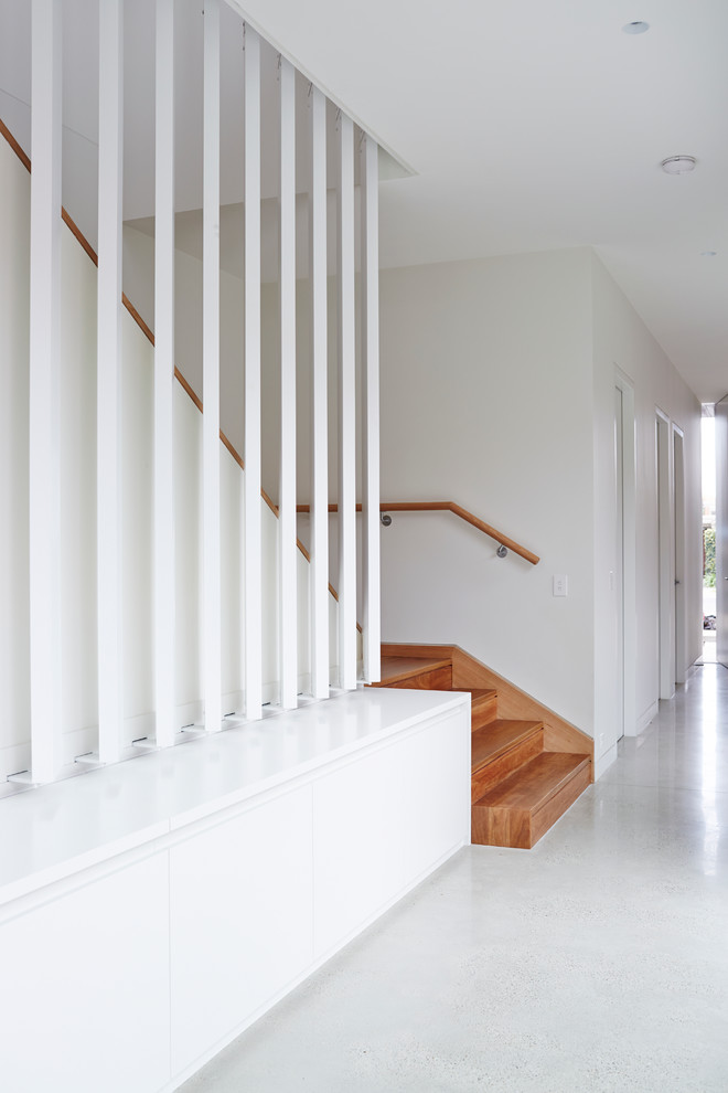 Contemporary wood l-shaped staircase in Melbourne with wood risers.