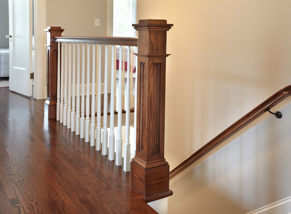 Example of a mid-sized transitional wooden straight staircase design in Minneapolis with painted risers