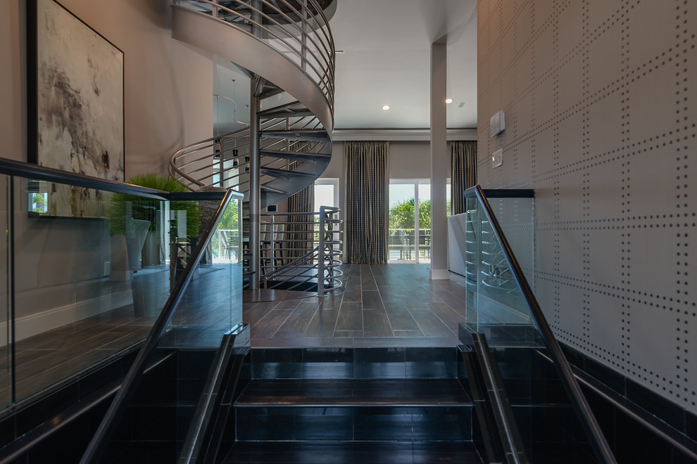 Example of a large trendy metal spiral open and metal railing staircase design in Tampa
