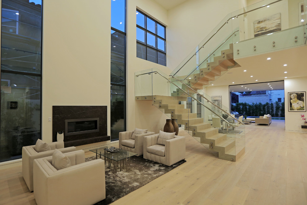 Staircase - huge contemporary wooden u-shaped staircase idea in Los Angeles with wooden risers