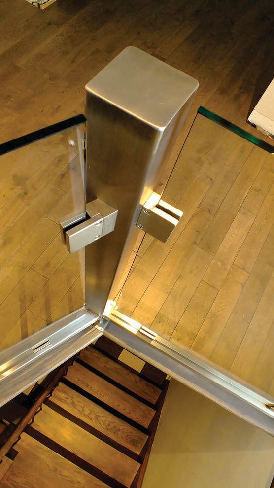 Bild på en mellanstor funkis l-trappa i trä, med sättsteg i trä och räcke i glas
