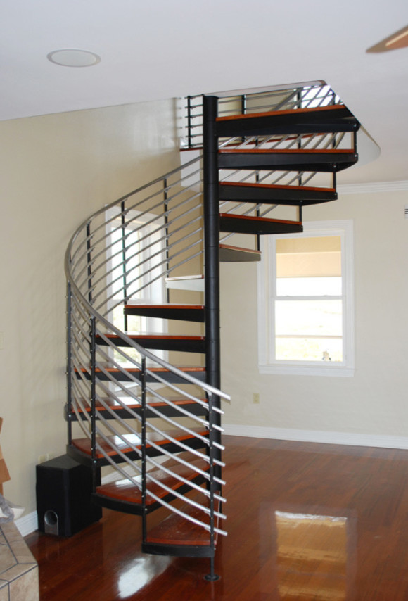 Inspiration for a medium sized contemporary wood curved staircase in San Diego with wood risers and feature lighting.