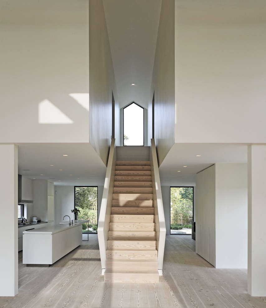 Modern wood straight staircase in New York with wood risers.