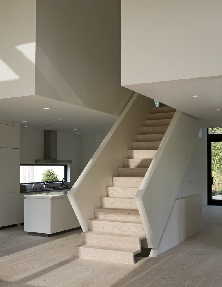 Inspiration for a contemporary wood straight staircase in New York with wood risers.
