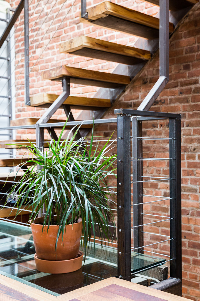 Staircase - industrial wooden straight open and metal railing staircase idea in New York