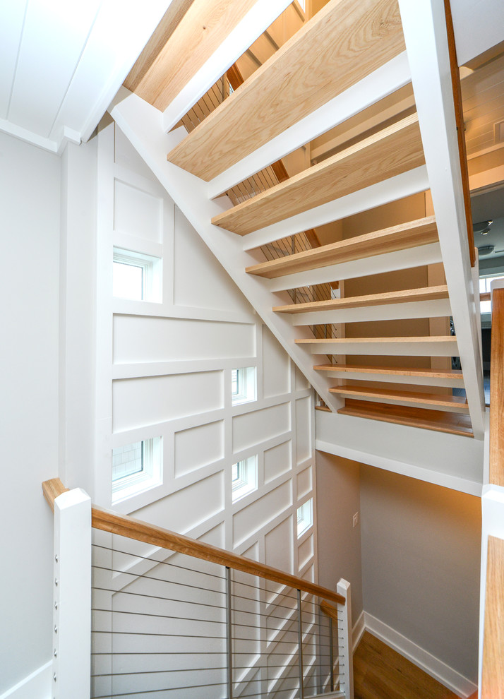 Mid-sized beach style wooden u-shaped open and cable railing staircase photo in Philadelphia