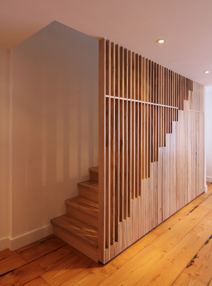 Staircase - mid-sized modern wooden straight staircase idea in New York with wooden risers