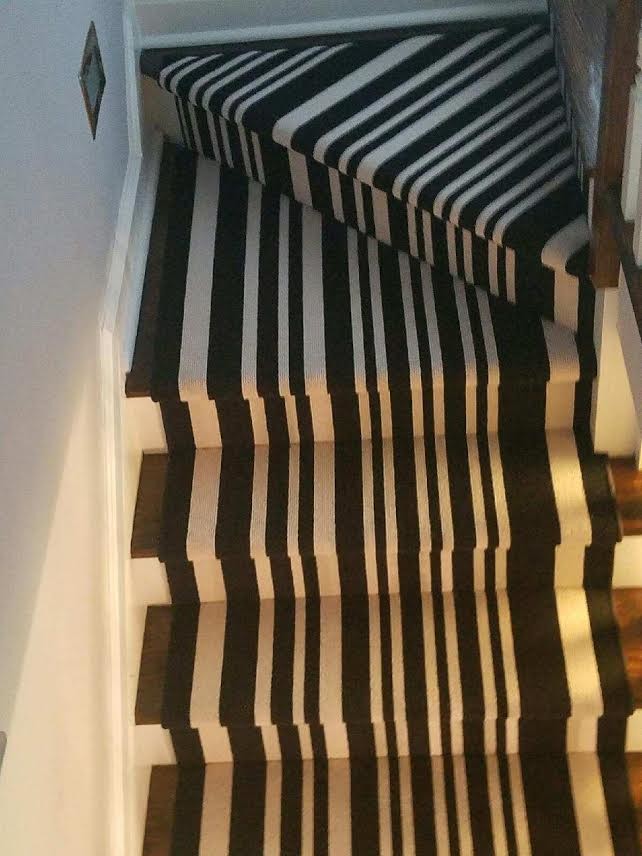 Imagen de escalera recta bohemia de tamaño medio con escalones enmoquetados, contrahuellas enmoquetadas y barandilla de madera