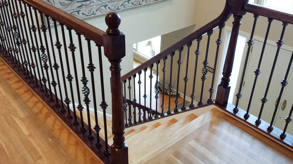 This is an example of a medium sized traditional wood l-shaped metal railing staircase in New York with wood risers.