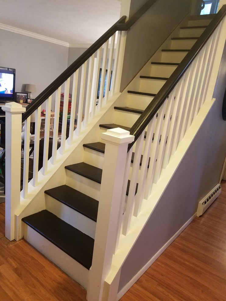 This is an example of a medium sized traditional wood straight wood railing staircase in New York with wood risers.