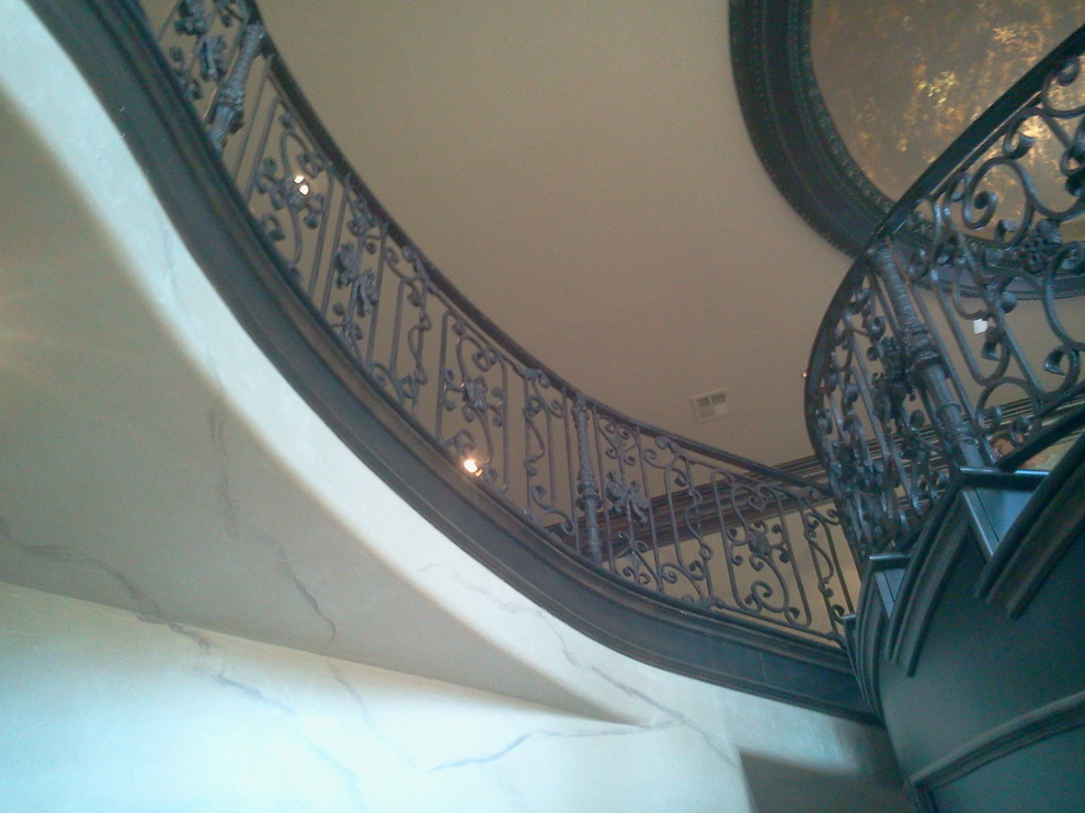 Example of a mid-sized classic wooden curved staircase design in Oklahoma City with wooden risers