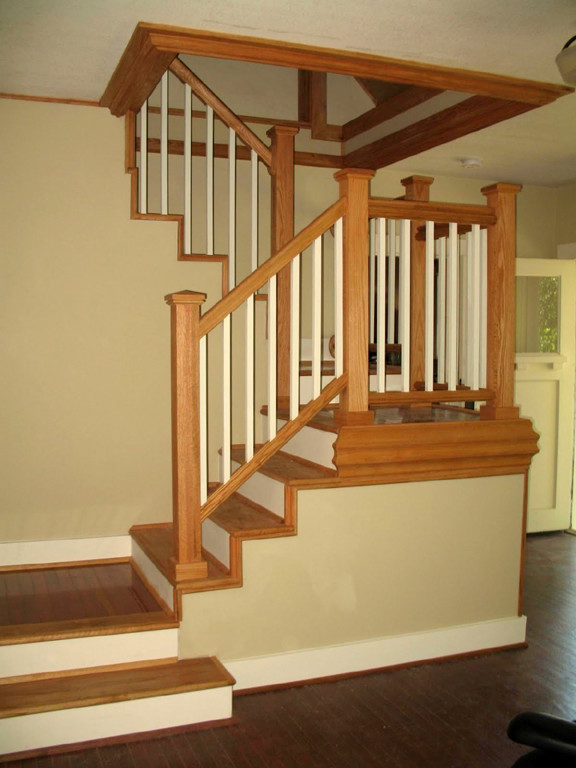 Photo of a medium sized classic wood u-shaped staircase in Portland with wood risers.