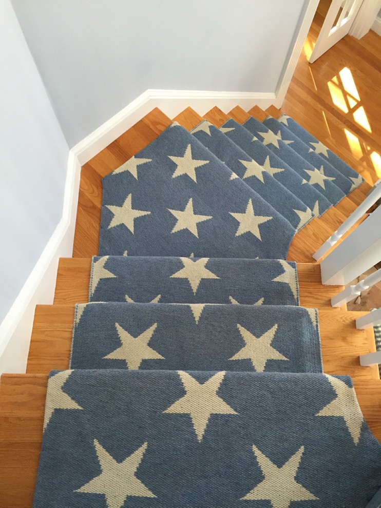 Inspiration for a small coastal carpeted curved staircase remodel in Boston with carpeted risers