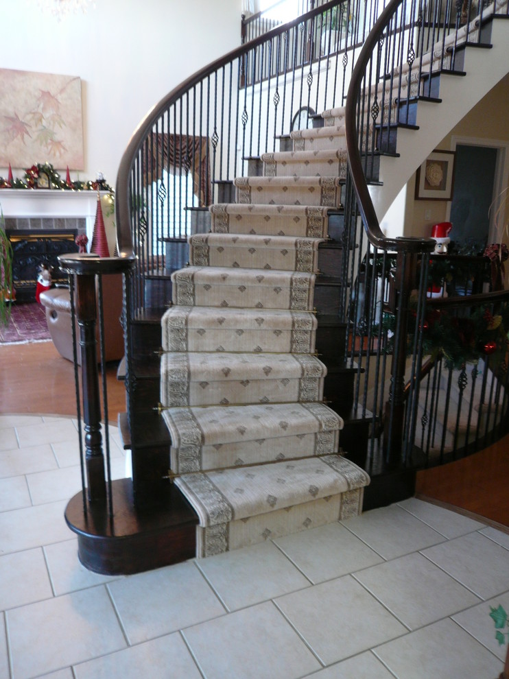 Inspiration for a mid-sized timeless wooden curved staircase remodel in Ottawa with wooden risers