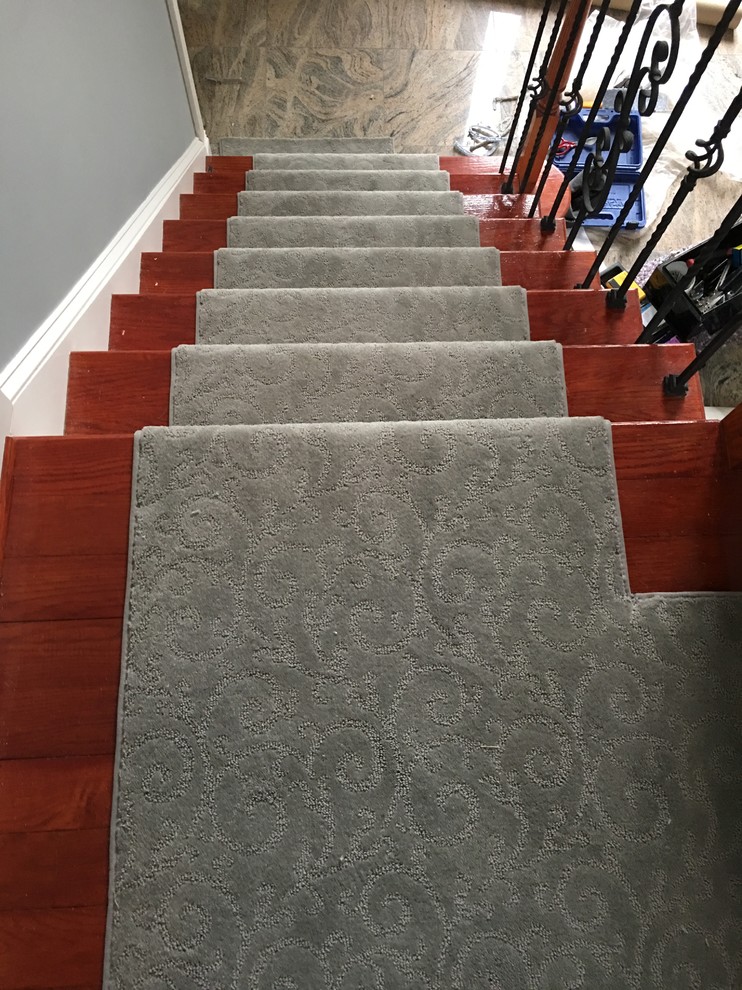 Example of a mid-sized classic carpeted straight staircase design in New York with carpeted risers