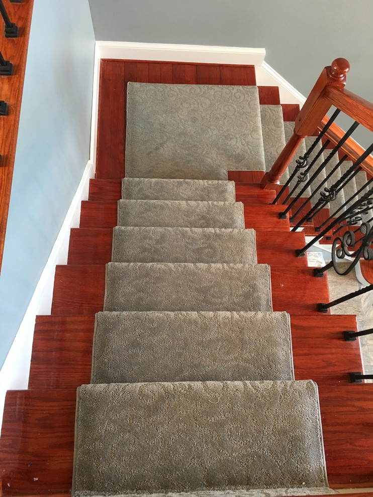 Medium sized traditional carpeted straight staircase in New York with carpeted risers.