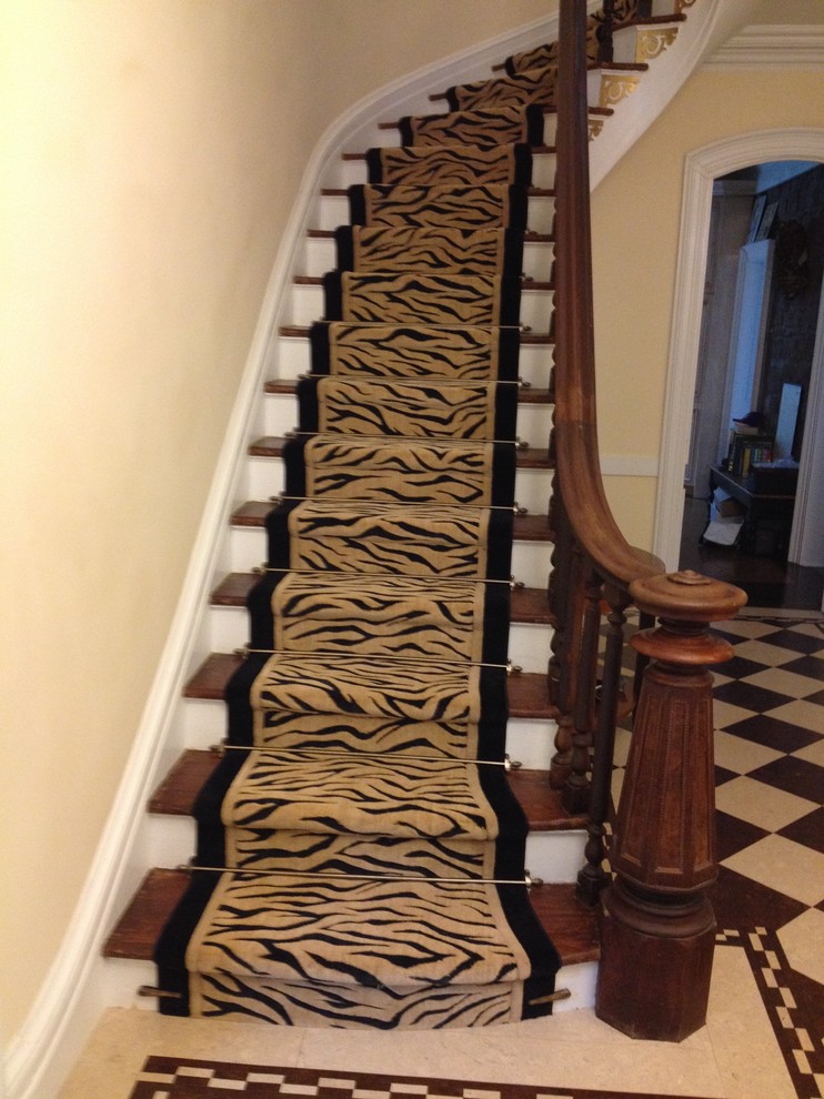 Large transitional wooden curved staircase photo in New York with wooden risers