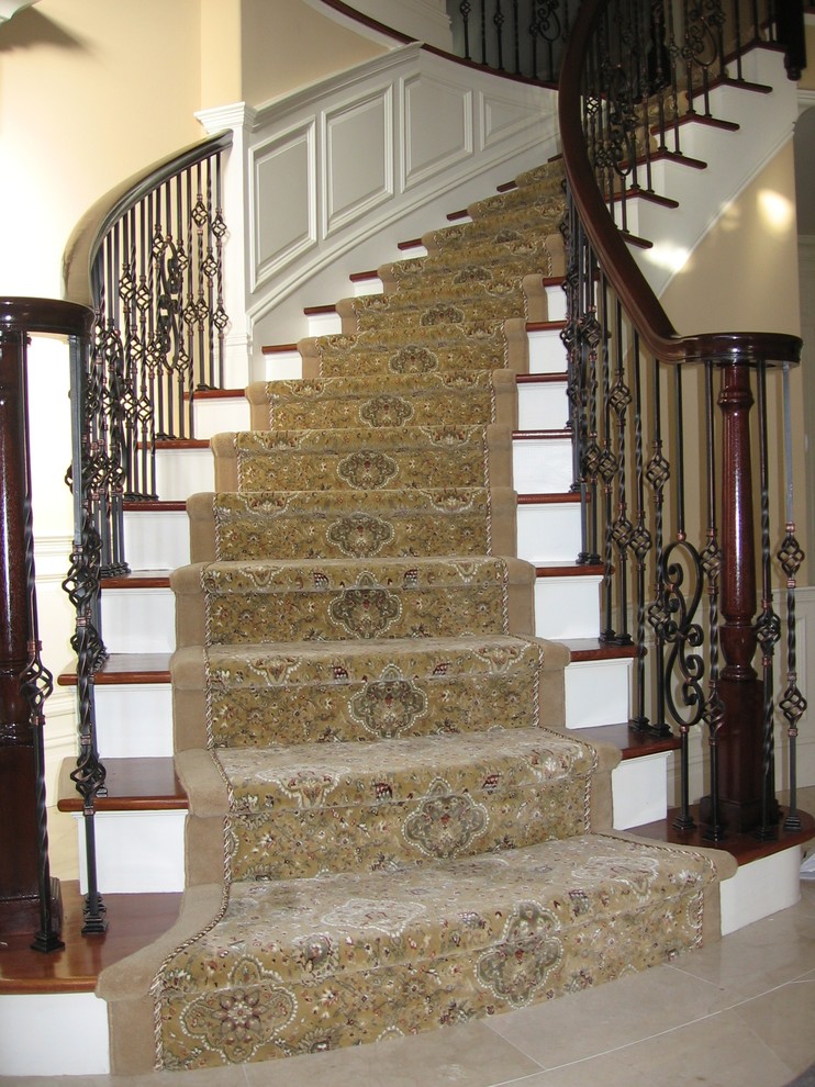Staircase - mid-sized traditional wooden curved staircase idea in New York with painted risers