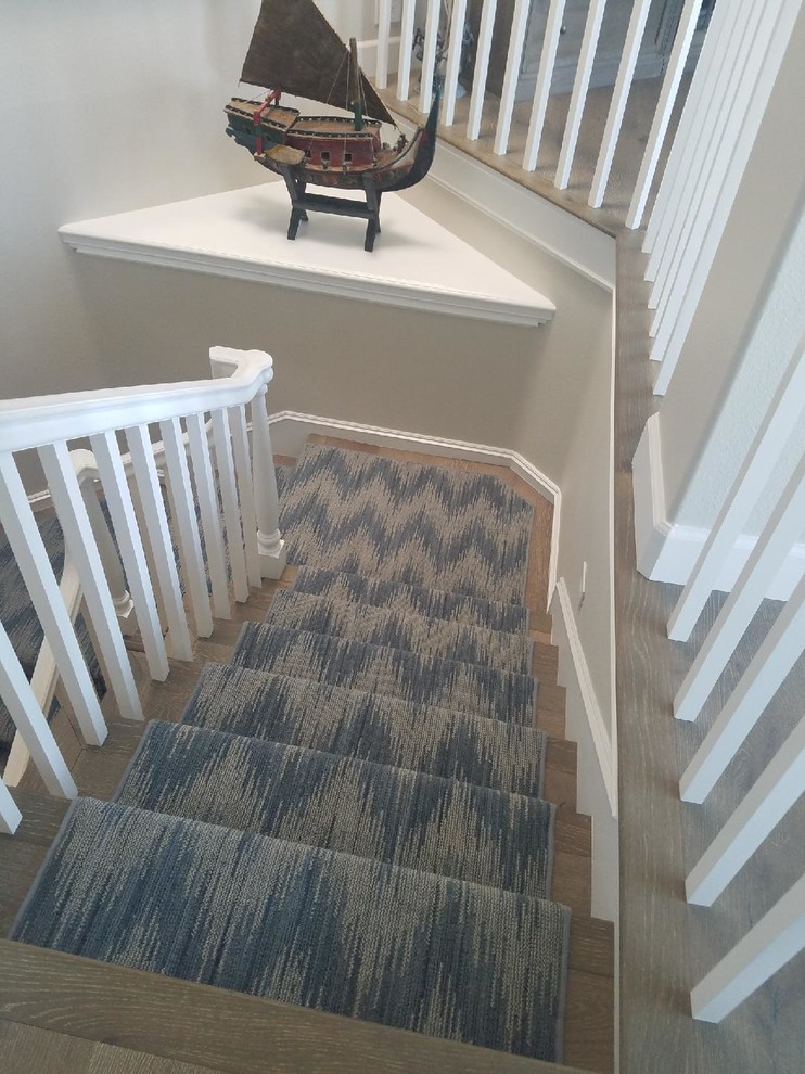 Photo of a traditional wood wood railing staircase in Orange County with painted wood risers.