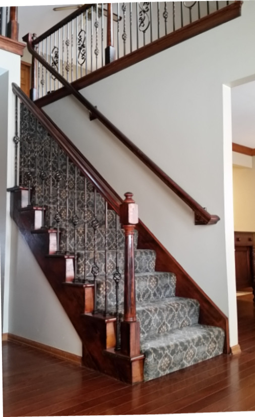 Example of a mid-sized classic wooden straight staircase design in St Louis with wooden risers