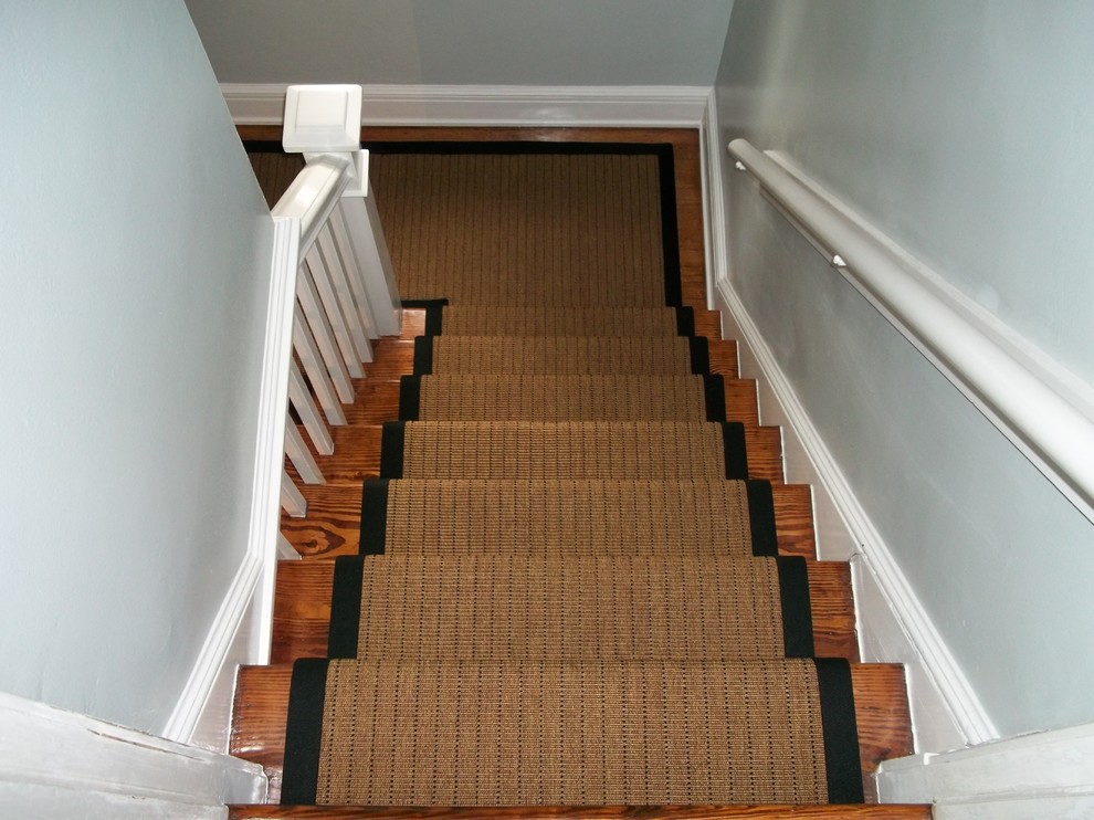 Medium sized traditional wood u-shaped staircase in Tampa with wood risers.