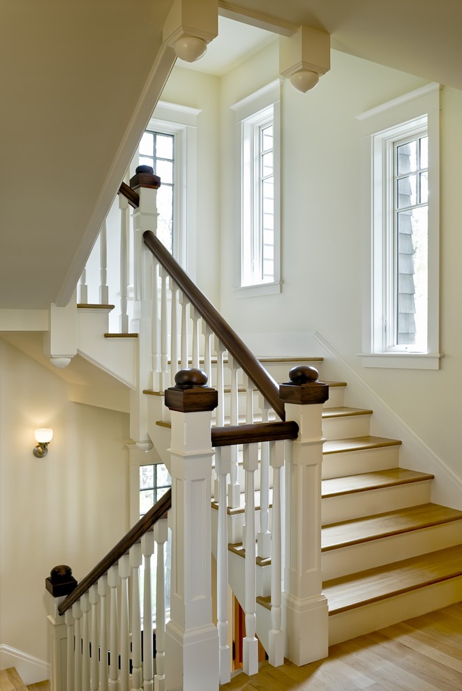 This is an example of a traditional wood staircase in Burlington with painted wood risers.