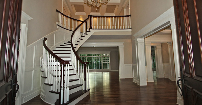 Medium sized traditional wood curved staircase in New Orleans with painted wood risers.