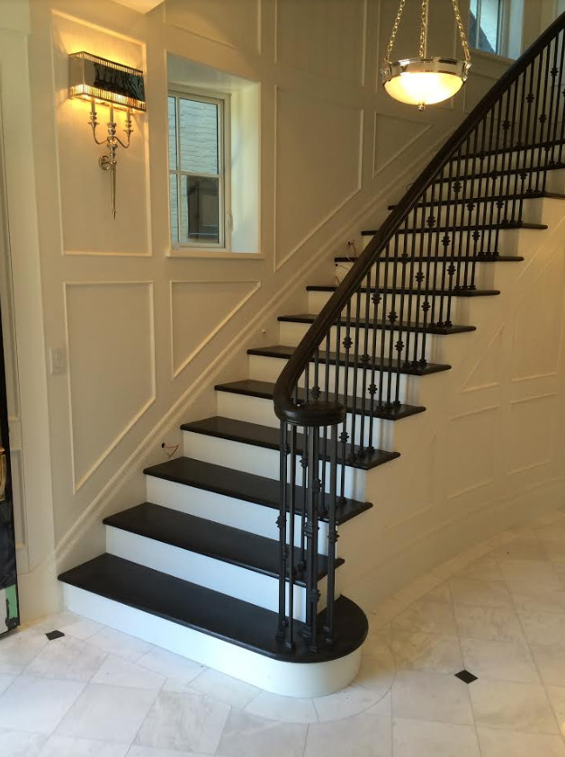 Inspiration for a large classic painted wood curved mixed railing staircase in Vancouver with painted wood risers.