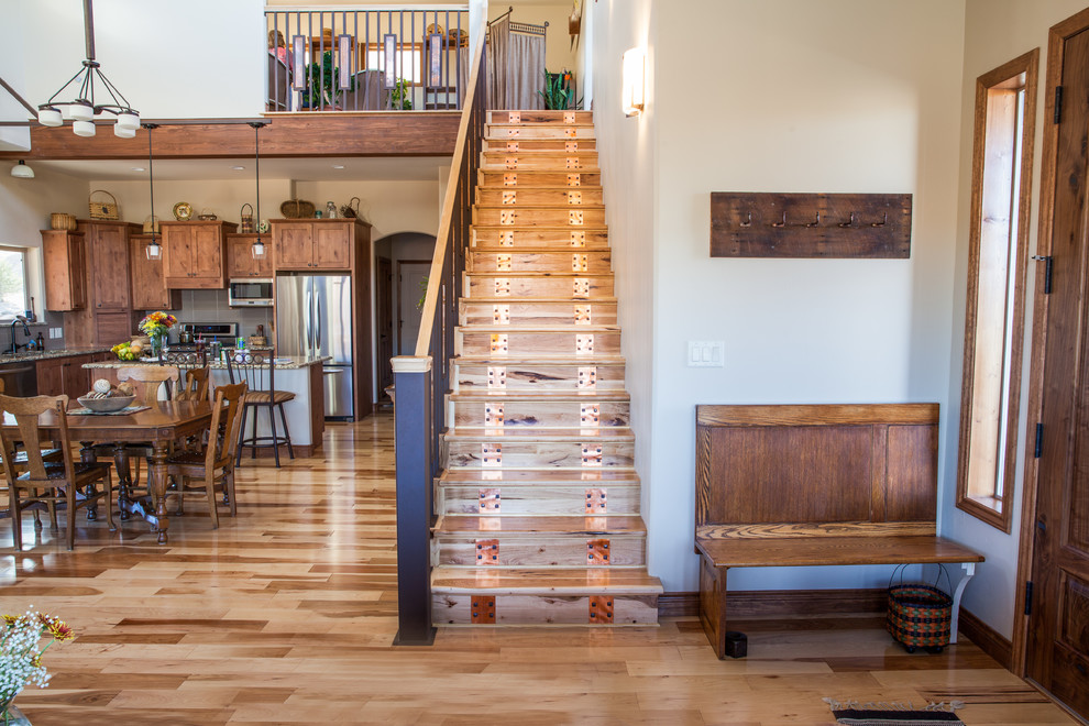 Medium sized classic wood straight metal railing staircase in Albuquerque with metal risers.