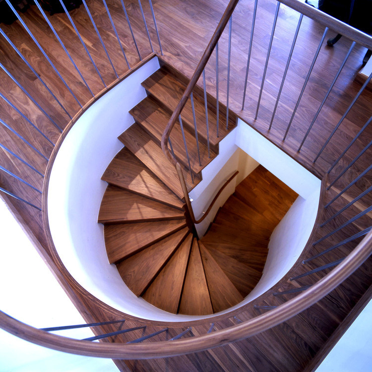 Staircase - small contemporary wooden curved staircase idea in New York with wooden risers
