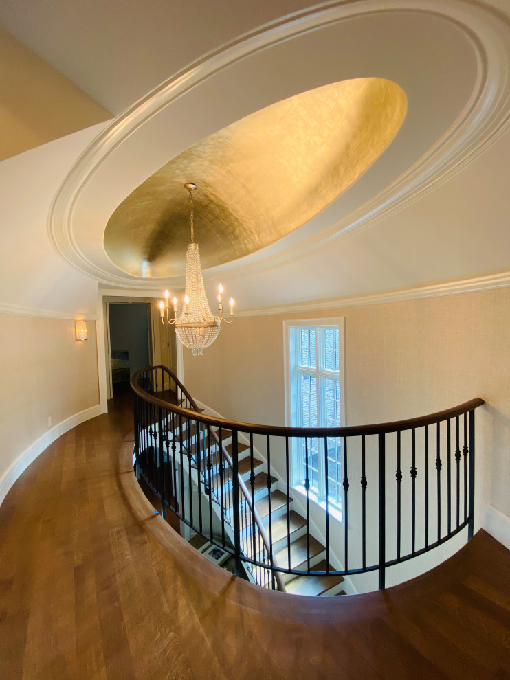 Example of a transitional wooden metal railing and wallpaper staircase design in Seattle with painted risers