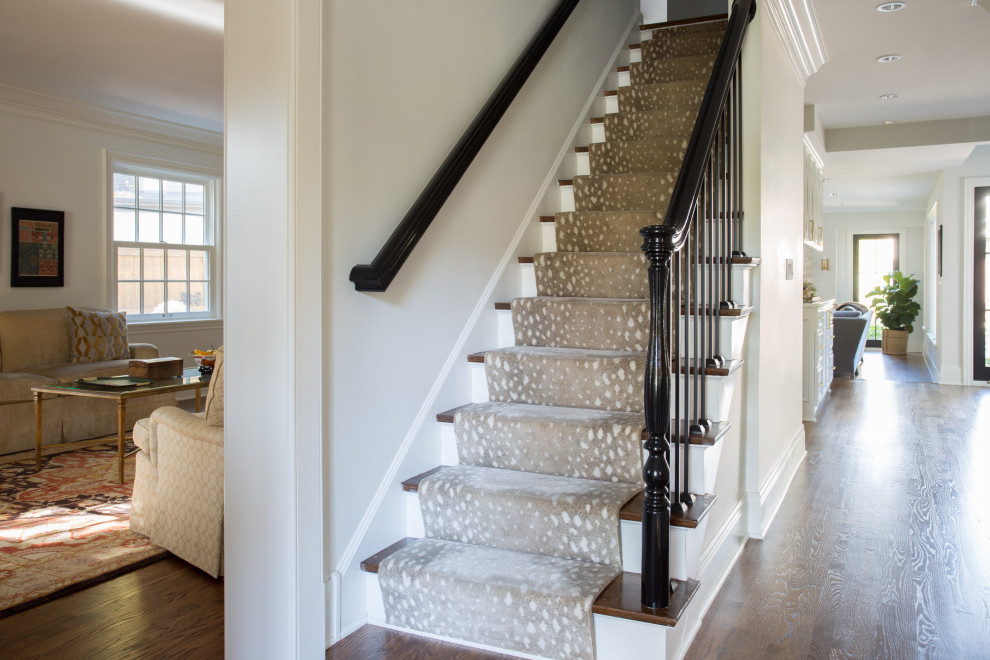Mid-sized elegant straight metal railing staircase photo in Columbus with carpeted risers