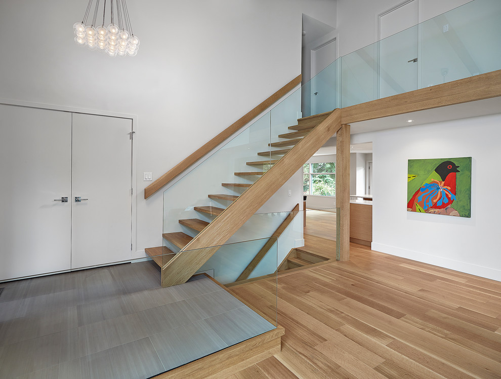 This is an example of a contemporary wood straight staircase in Edmonton with open risers.