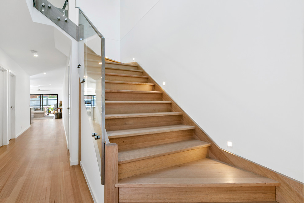 Design ideas for a medium sized contemporary wood glass railing staircase in Melbourne with wood risers.