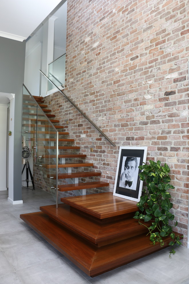 Photo of a contemporary wood straight staircase in Sydney with open risers.