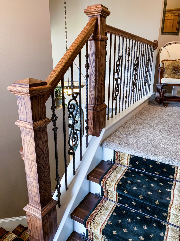 Photo of a medium sized classic wood u-shaped mixed railing staircase in Seattle with wood risers.